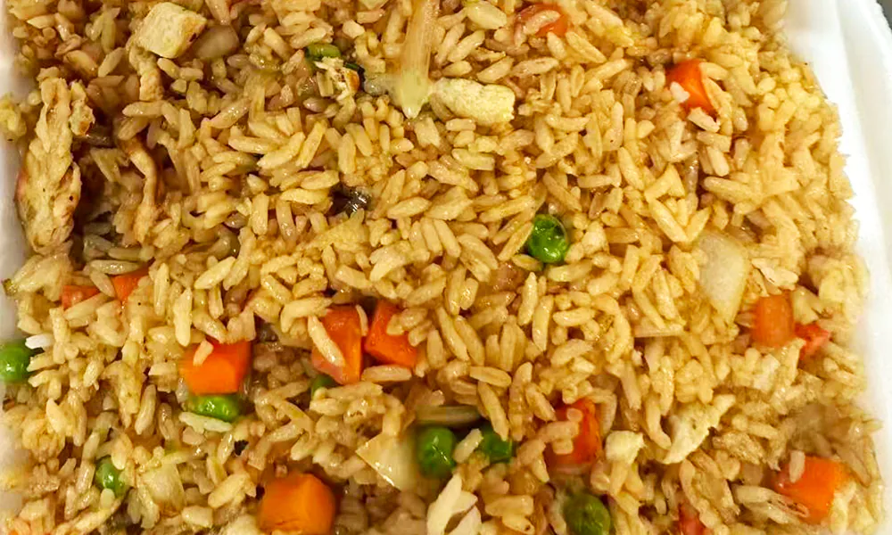 Fried rice mixed with chicken, carrots, peas, and other vegetables at Kick Off Wings, a Fast Food Restaurant in Carrollton