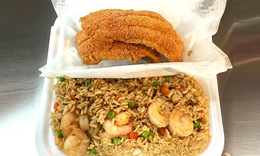 Fried fish served with shrimp fried rice mixed with vegetables at Kick Off Wings, a Fast Food Restaurant in Carrollton
